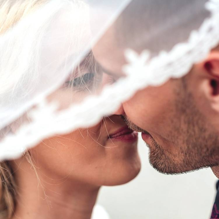 A couple kissing on their wedding day