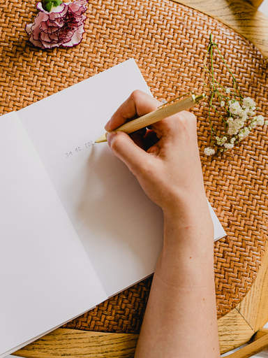 Woman writing a foreword in her wedding guest book