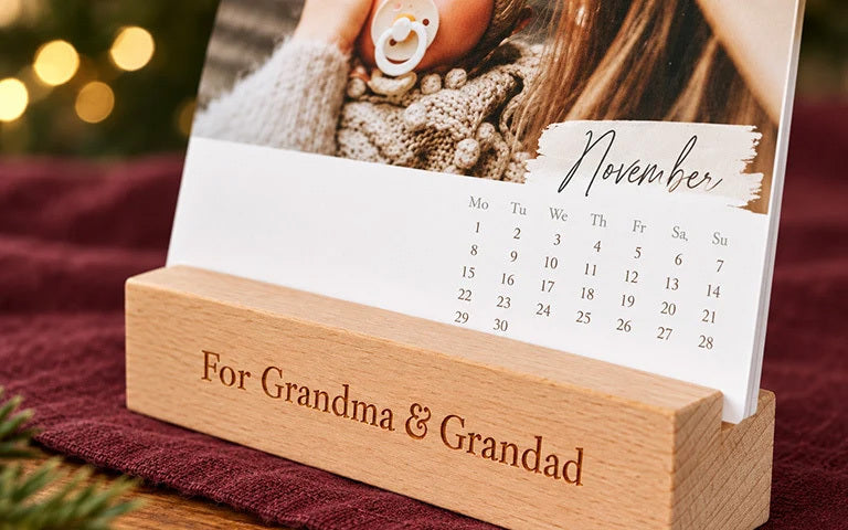 A desk calendar in a wooden stand engraved For Grandma & Grandad