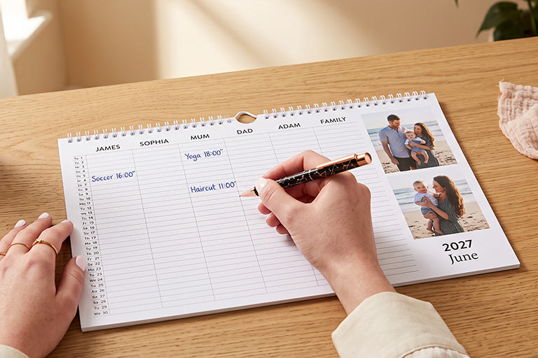 A family planner with a column for each family member and two beach photos