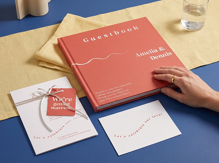 Coral wedding guest book, an invitation with a hang tag and a card, all from the same design set
