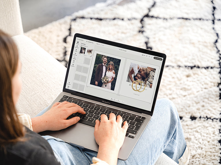 Woman designing a wedding photo book on a laptop, the online editor showing the couple's photos and gold rings