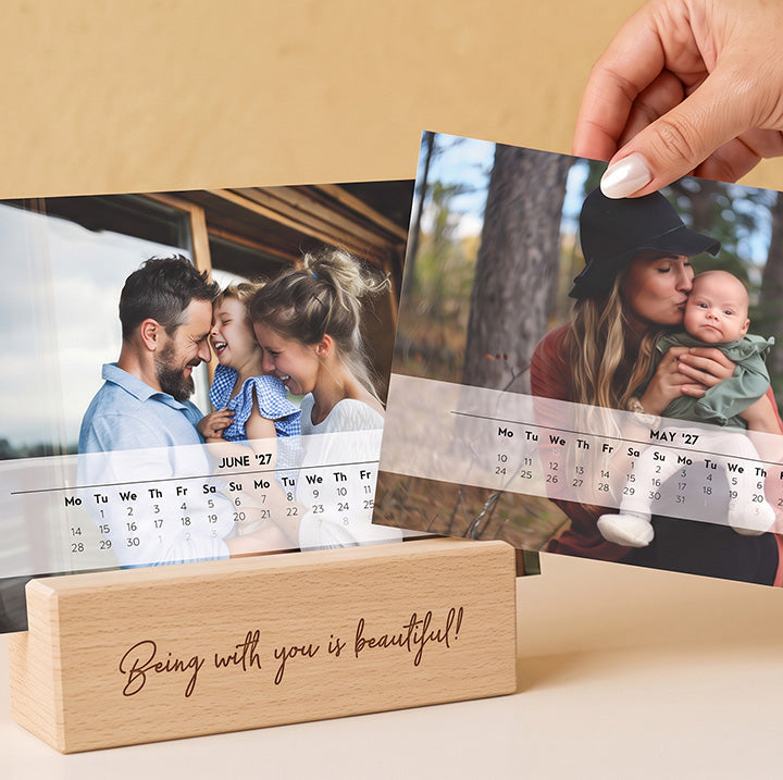 Two desk calendars with family photos in an engraved wooden stand
