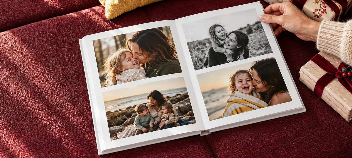An open photo book with family photos of a mother and her children, on a red sofa beside Christmas presents