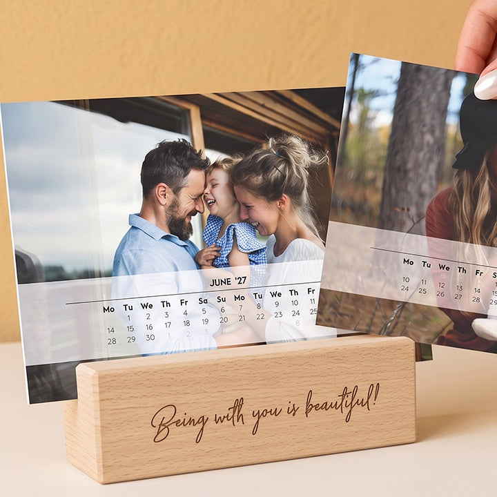 Two desk calendars with family photos in an engraved wooden stand
