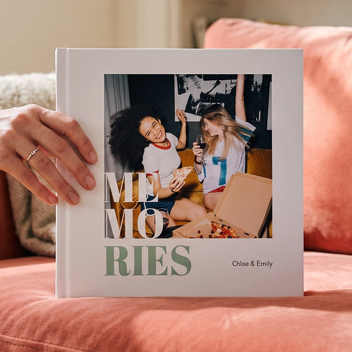 A friends photo book with the word MEMORIES and a photo of two friends on the cover